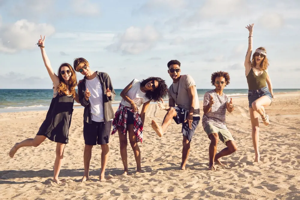 Group of friends jumping and having a good time on the beach
